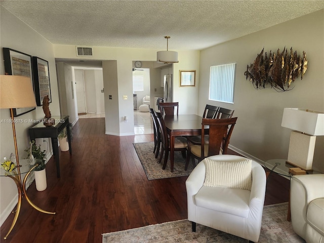 1601 SW 128th Ter Unit 201A, Pembroke Pines, FL 33027 - dining room featuring healthy amount of natural light, wood finished floors, a textured ceiling, and baseboards