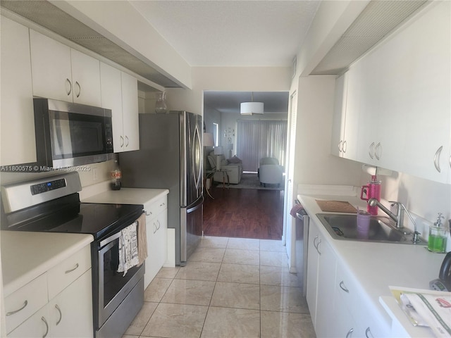 1601 SW 128th Ter Unit 201A, Pembroke Pines, FL 33027 - kitchen with appliances with stainless steel finishes, a sink, light countertops, and white cabinets