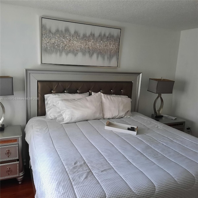1601 SW 128th Ter Unit 201A, Pembroke Pines, FL 33027 - bedroom with a textured ceiling and dark wood finished floors
