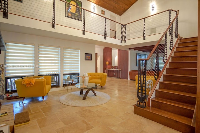 lobby featuring high vaulted ceiling, wood ceiling, and stairs