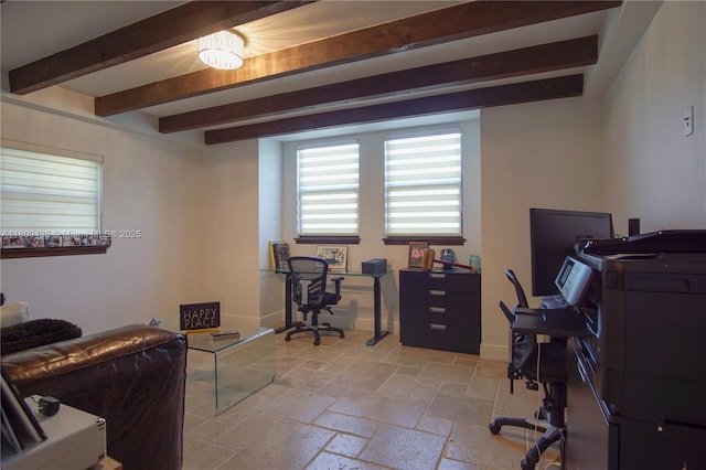 office featuring beamed ceiling, stone tile flooring, and baseboards