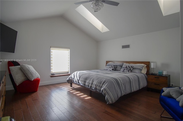 bedroom featuring a skylight, dark wood-type flooring, vaulted ceiling, and baseboards