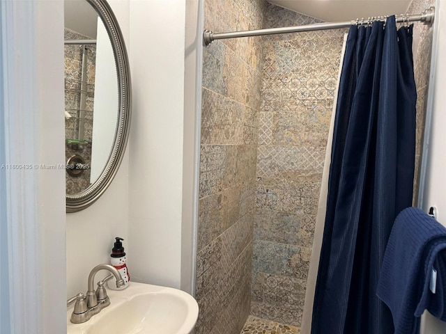 bathroom featuring a sink and a stall shower