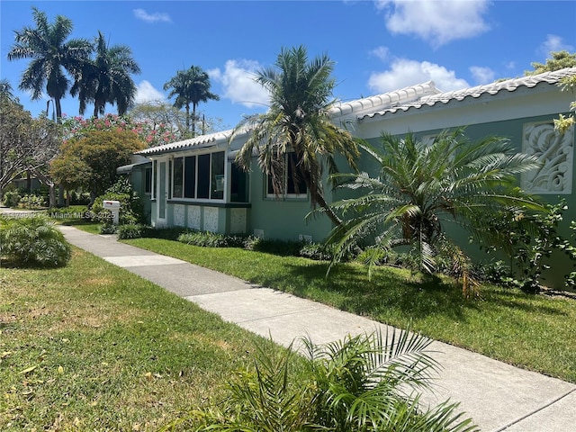 326 S 14th, Hollywood, FL 33020 - view of side of home with a yard, stucco siding, and a tile roof