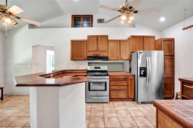 326 S 14th Ave, Hollywood, FL 33020 - kitchen with stainless steel appliances, ceiling fan, range hood, vaulted ceiling, and brown cabinets