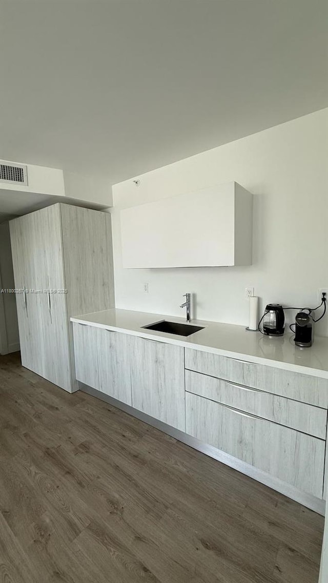 6080 Collins Ave Unit 402, Miami Beach, FL 33140 - laundry area featuring a sink and dark wood-type flooring