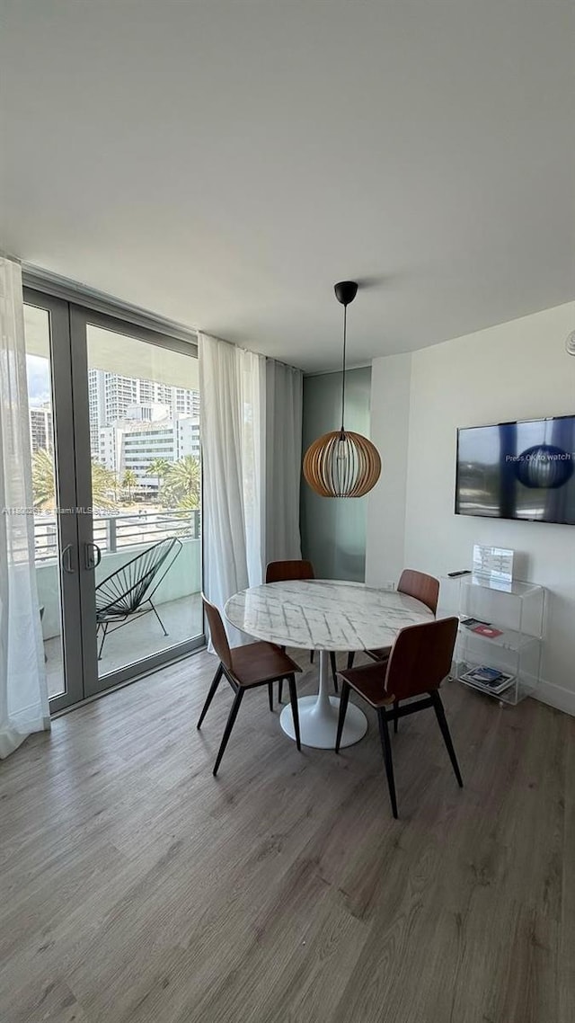 6080 Collins Ave Unit 402, Miami Beach, FL 33140 - dining space with wood finished floors, expansive windows, and french doors