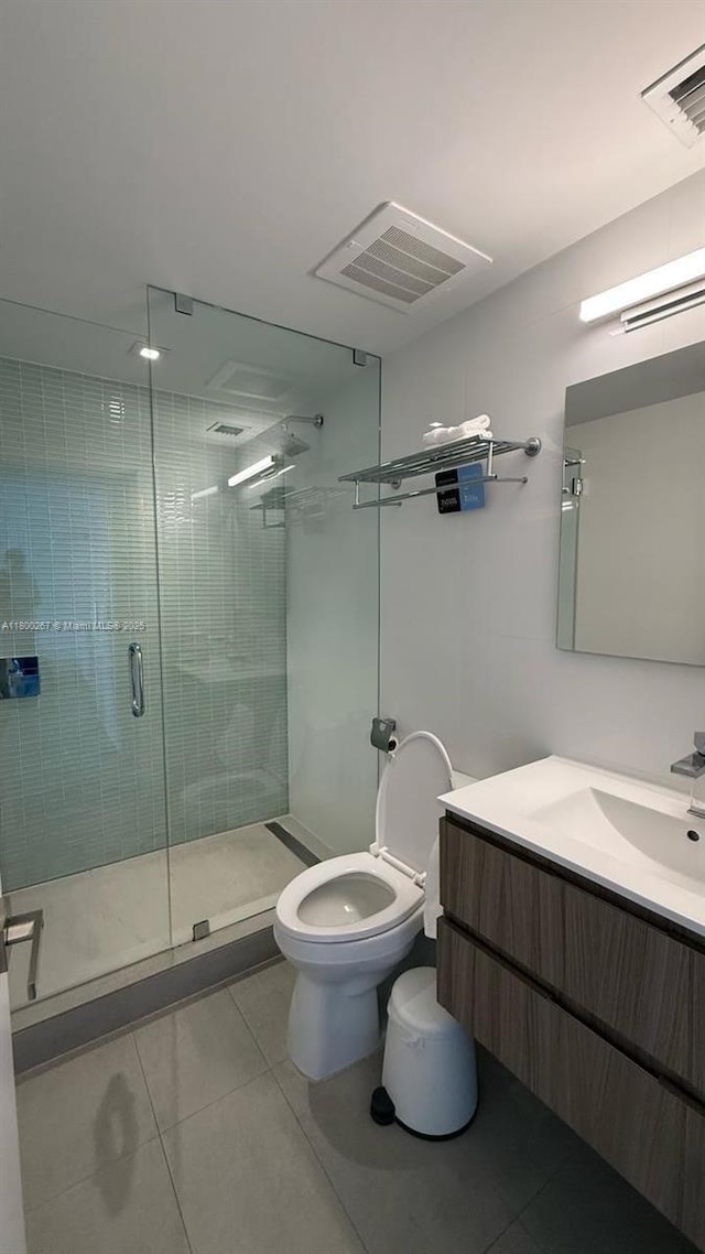 6080 Collins Ave Unit 402, Miami Beach, FL 33140 - bathroom with tile patterned flooring, a shower stall, toilet, and vanity