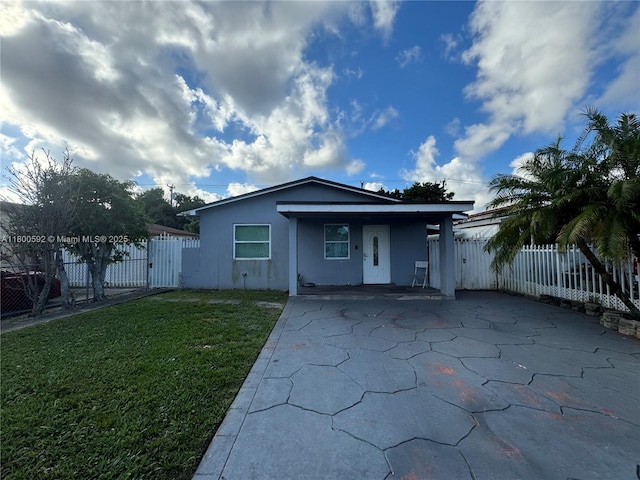 view of front of house featuring stucco siding and a gate