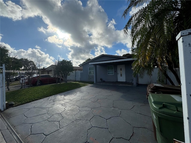 back of house with a patio area, stucco siding, and driveway