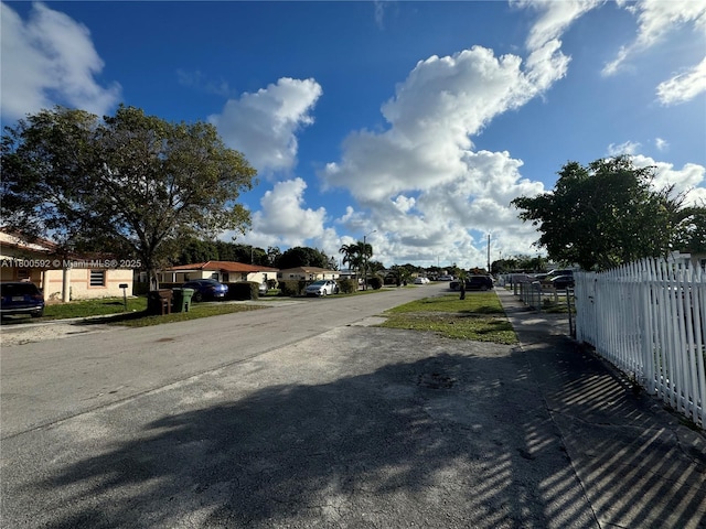 view of asphalt road featuring street lighting