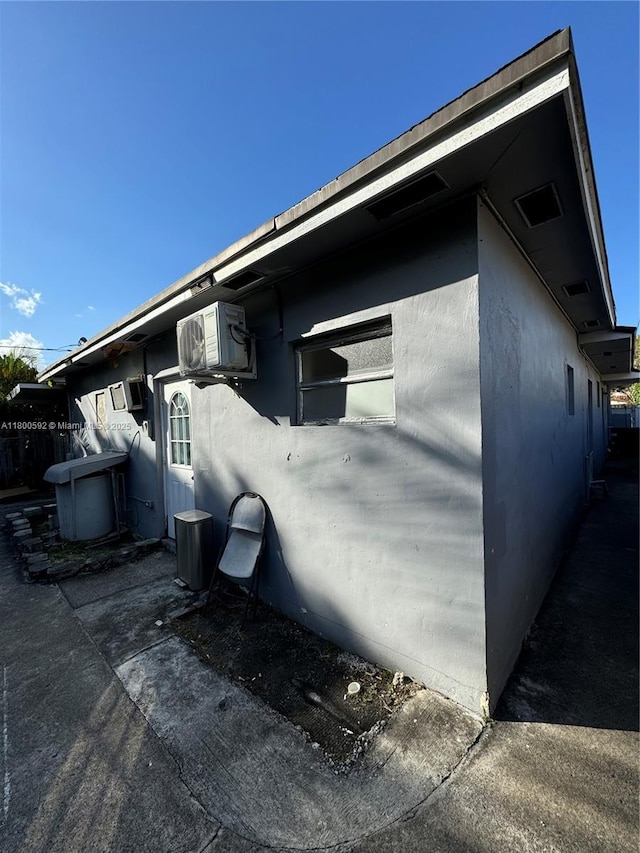 view of side of home featuring a cooling unit