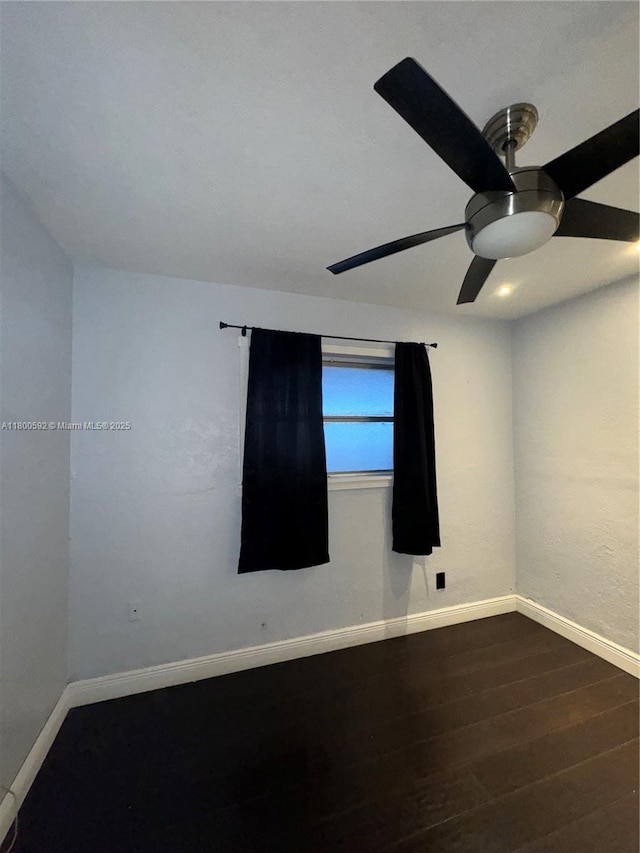 unfurnished room with ceiling fan, baseboards, and wood finished floors