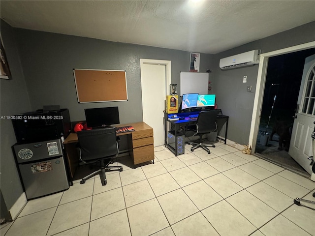 office space with a wall mounted air conditioner, a textured ceiling, and light tile patterned flooring