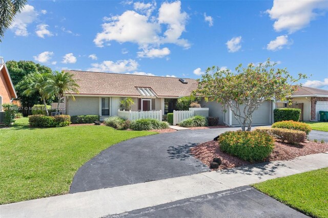 8400 NW 52nd St, Lauderhill, FL 33351 - ranch-style house featuring driveway, a front yard, stucco siding, a garage, and roof with shingles