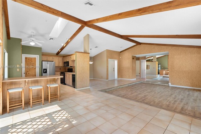 8400 NW 52nd St, Lauderhill, FL 33351 - kitchen with black appliances, open floor plan, a peninsula, light countertops, and a skylight