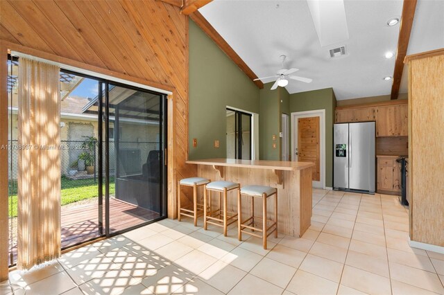 8400 NW 52nd St, Lauderhill, FL 33351 - kitchen with stainless steel fridge, vaulted ceiling, a peninsula, light tile patterned floors, and a ceiling fan
