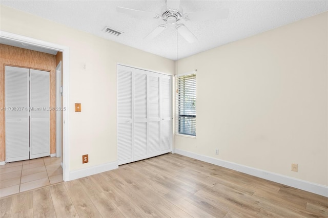 8400 NW 52nd St, Lauderhill, FL 33351 - unfurnished bedroom with baseboards, wood finished floors, a closet, ceiling fan, and a textured ceiling