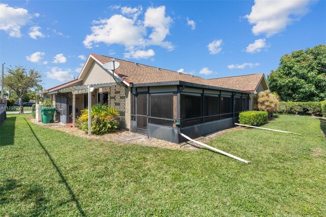 8400 NW 52nd St, Lauderhill, FL 33351 - rear view of property featuring a sunroom and a yard