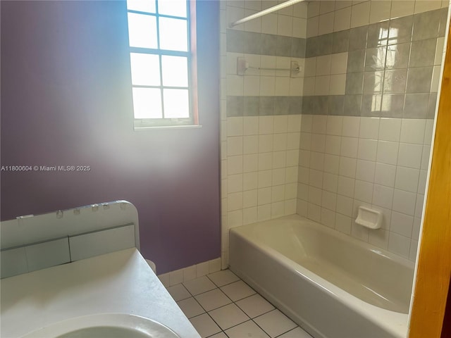 bathroom featuring tile patterned floors, baseboards, and bathing tub / shower combination