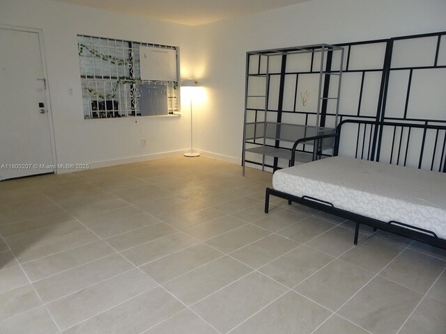 13500 NE 3rd Ct Unit 217, North Miami, FL 33161 - bedroom with tile patterned floors and baseboards