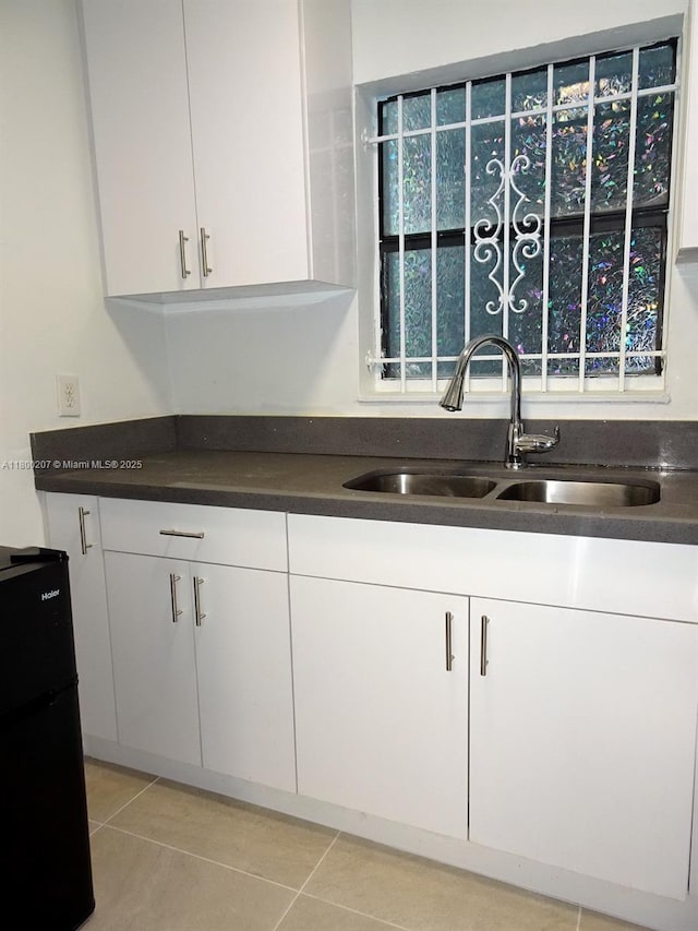 13500 NE 3rd Ct Unit 217, North Miami, FL 33161 - kitchen featuring a sink, freestanding refrigerator, white cabinets, and dark countertops