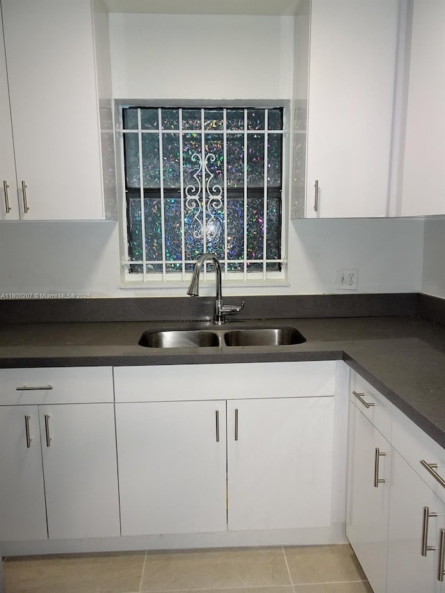 13500 NE 3rd Ct Unit 217, North Miami, FL 33161 - kitchen featuring white cabinets and dark countertops