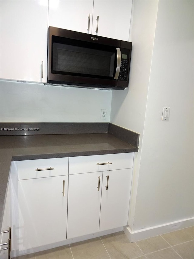 13500 NE 3rd Ct Unit 217, North Miami, FL 33161 - detailed view of white cabinetry and dark countertops