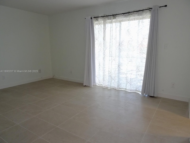 13500 NE 3rd Ct Unit 217, North Miami, FL 33161 - spare room with tile patterned floors and baseboards