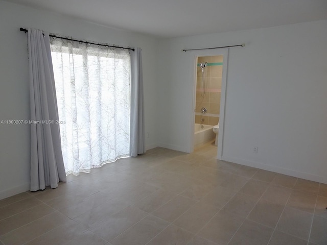 13500 NE 3rd Ct Unit 217, North Miami, FL 33161 - spare room featuring light tile patterned floors and baseboards