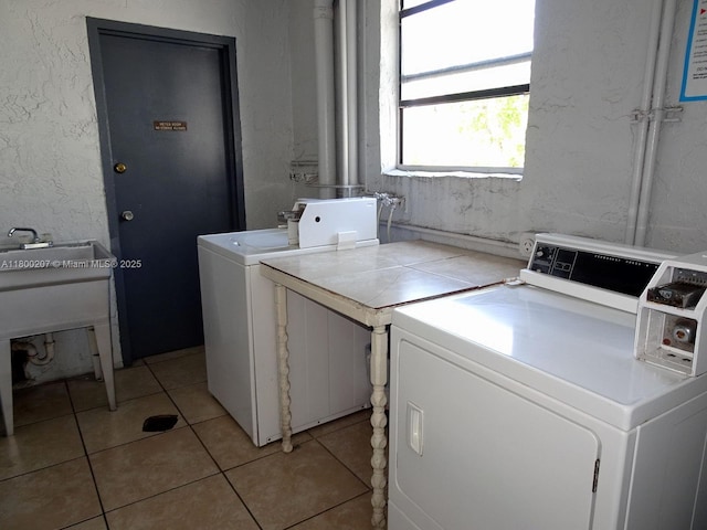 13500 NE 3rd Ct Unit 217, North Miami, FL 33161 - shared laundry room featuring washer and clothes dryer, light tile patterned floors, and a textured wall