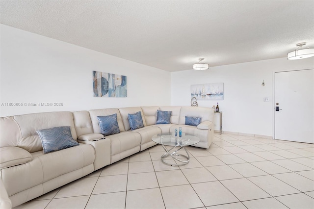 living room featuring a textured ceiling and light tile patterned floors