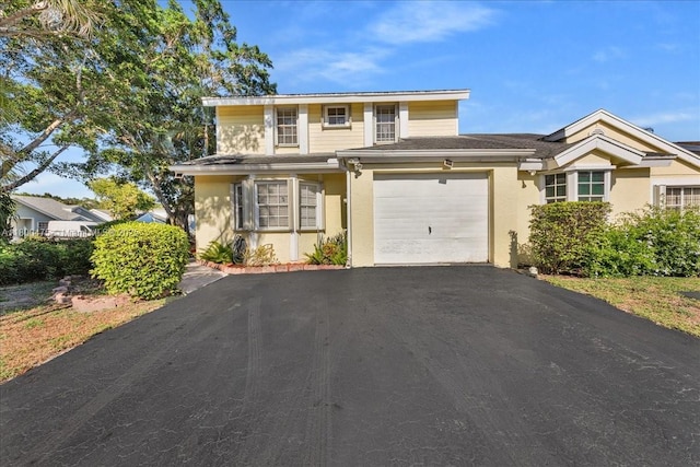 1060 SW 111th Way, Davie, FL 33324 - traditional-style house with asphalt driveway, stucco siding, and a garage