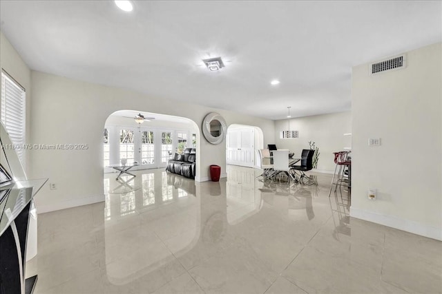 1060 SW 111th Way, Davie, FL 33324 - living room with arched walkways, baseboards, recessed lighting, and a ceiling fan