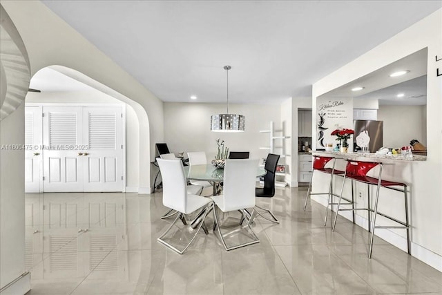 1060 SW 111th Way, Davie, FL 33324 - dining room featuring arched walkways, recessed lighting, light tile patterned floors, and baseboards