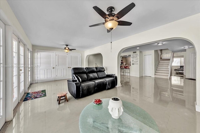 1060 SW 111th Way, Davie, FL 33324 - living room with arched walkways, ceiling fan, tile patterned floors, and stairway