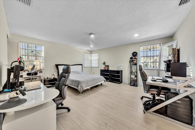 1060 SW 111th Way, Davie, FL 33324 - bedroom featuring a textured ceiling, an office area, multiple windows, wood finished floors, and recessed lighting