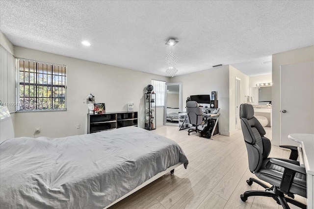 1060 SW 111th Way, Davie, FL 33324 - bedroom with light wood finished floors, a textured ceiling, and a desk