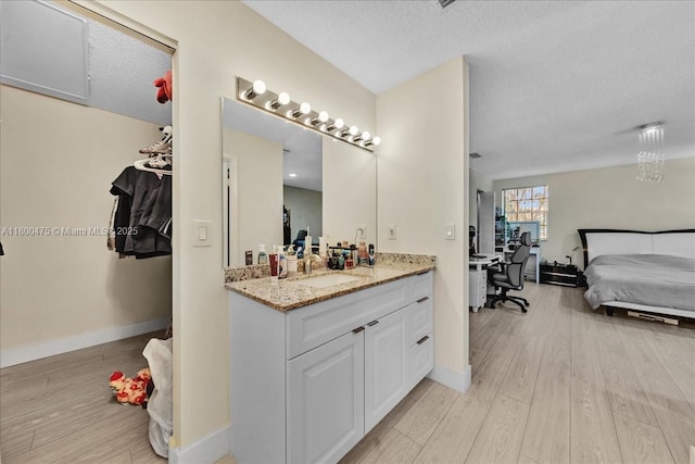1060 SW 111th Way, Davie, FL 33324 - bathroom featuring ensuite bath, wood finished floors, baseboards, vanity, and a textured ceiling
