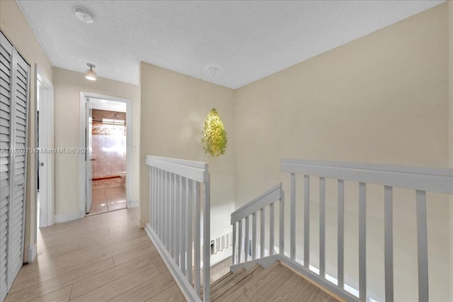 1060 SW 111th Way, Davie, FL 33324 - corridor with an upstairs landing, wood finished floors, and a textured ceiling