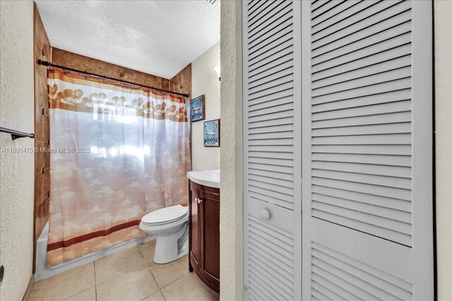 1060 SW 111th Way, Davie, FL 33324 - bathroom featuring a closet, a textured ceiling, tile patterned floors, a textured wall, and toilet