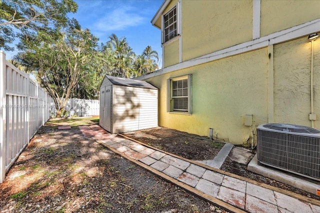 1060 SW 111th Way, Davie, FL 33324 - fenced backyard with central AC, a storage unit, and an outbuilding