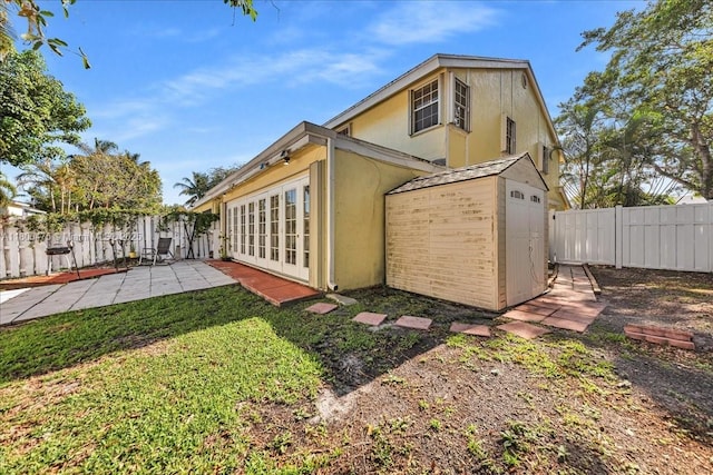 1060 SW 111th Way, Davie, FL 33324 - back of property with stucco siding, a patio area, an outbuilding, and a storage unit
