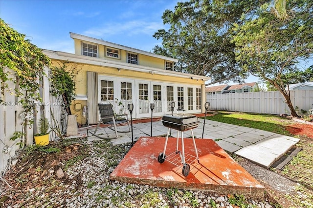 1060 SW 111th Way, Davie, FL 33324 - rear view of house with french doors, a fenced backyard, a patio, and stucco siding