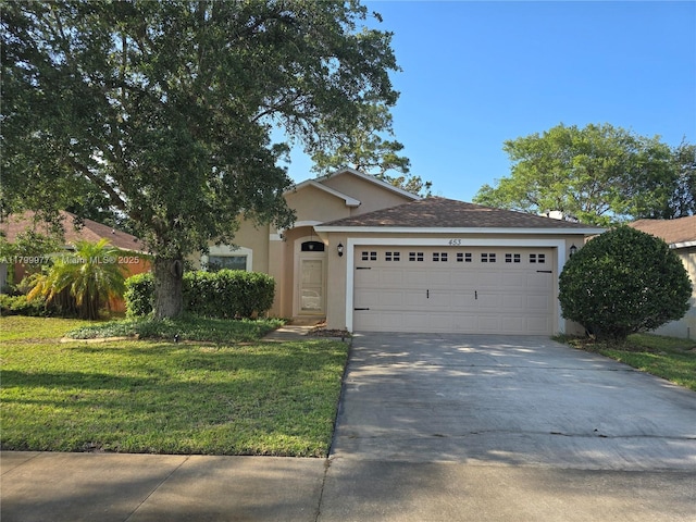 453 Dahoon Holly Dr, Daytona Beach, FL 32117 - view of front facade with stucco siding, driveway, a front lawn, and a garage