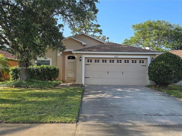 453 Dahoon Holly Dr, Daytona Beach, FL 32117 - view of front of home featuring stucco siding, a garage, driveway, and a front yard