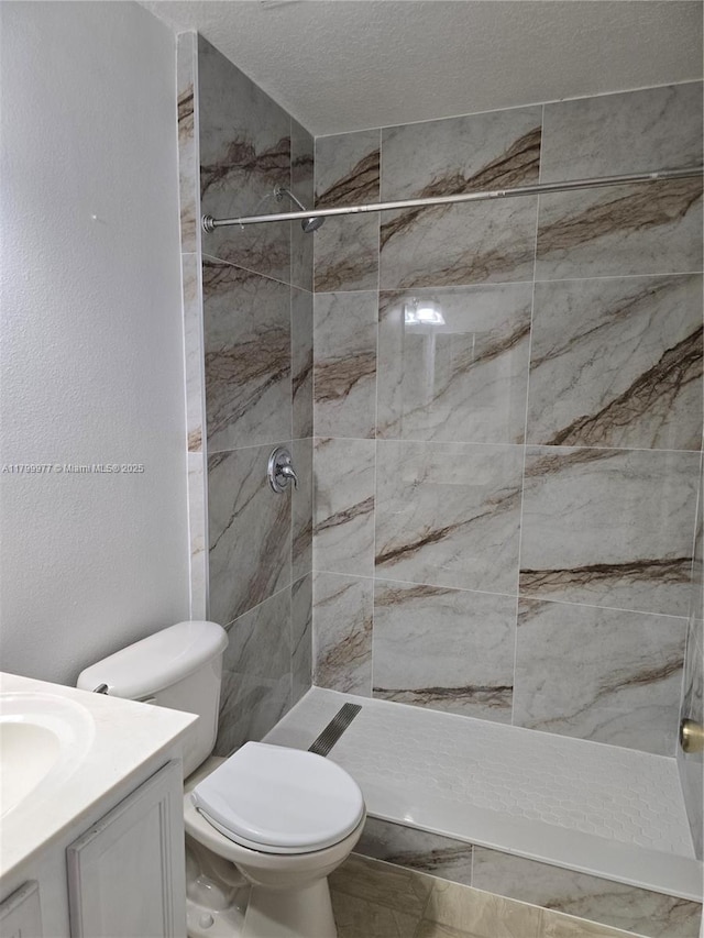 453 Dahoon Holly Dr, Daytona Beach, FL 32117 - bathroom featuring toilet, vanity, a stall shower, and a textured ceiling