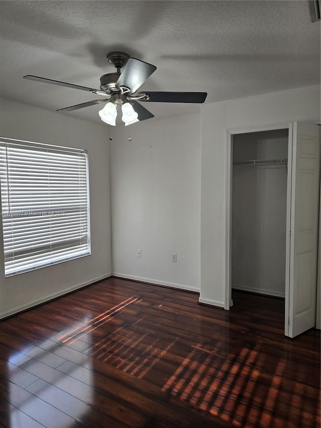 453 Dahoon Holly Dr, Daytona Beach, FL 32117 - unfurnished bedroom featuring wood finished floors, a textured ceiling, a closet, a ceiling fan, and baseboards