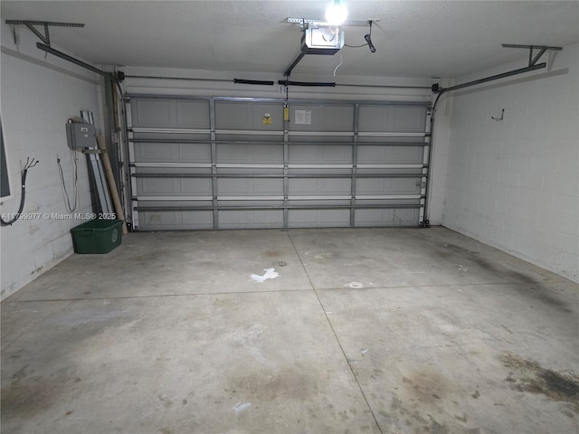 453 Dahoon Holly Dr, Daytona Beach, FL 32117 - garage with a garage door opener and concrete block wall