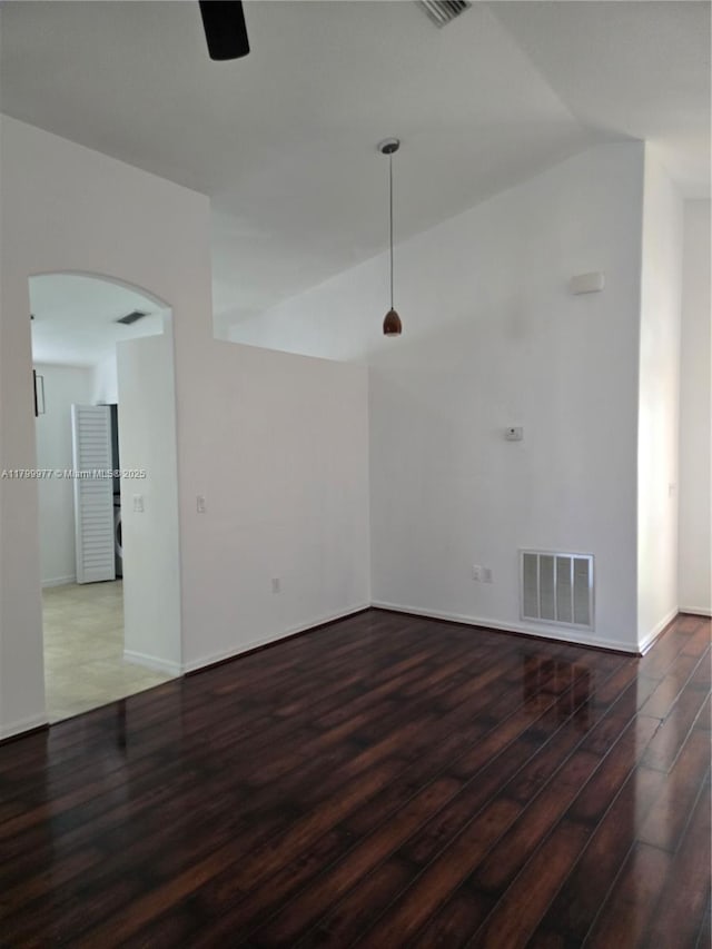 453 Dahoon Holly Dr, Daytona Beach, FL 32117 - spare room with lofted ceiling, wood finished floors, ceiling fan, arched walkways, and baseboards
